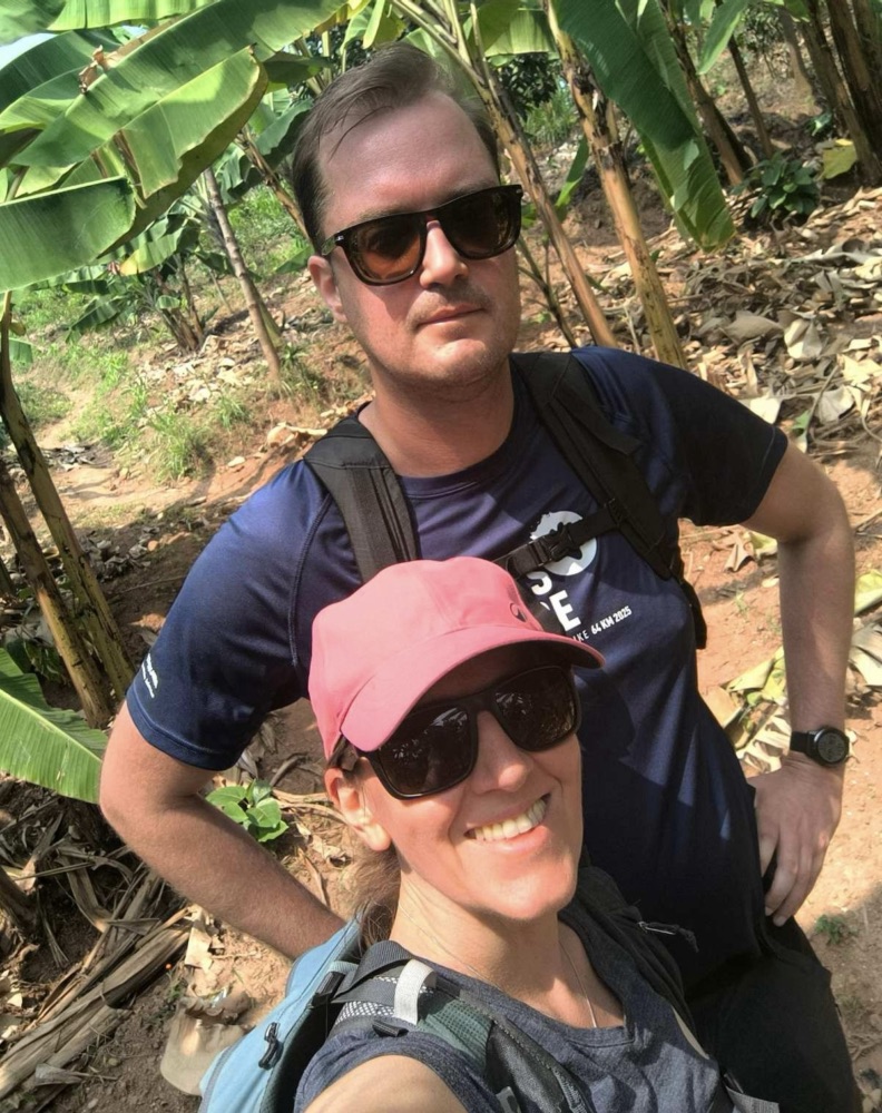 Simon and Sonja sampling local food on a community walk — your companions for these hikes